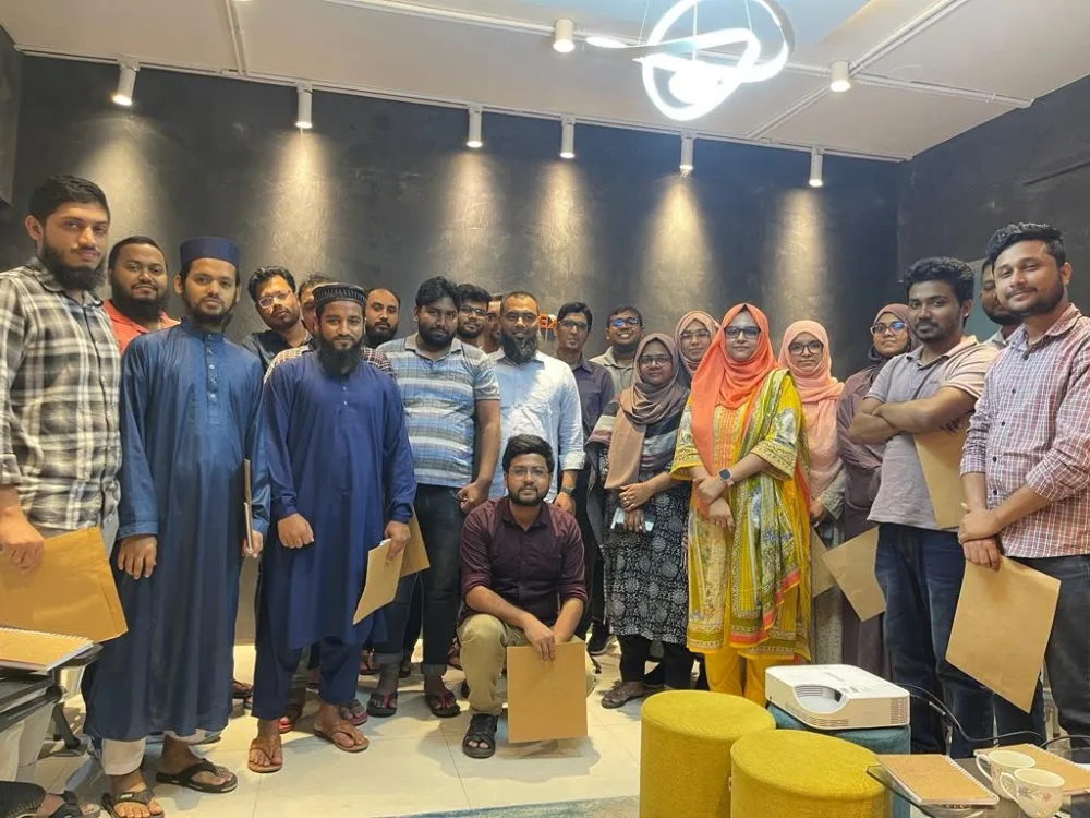 Participants gathered for a group photograph holding their course certificate envelopes at the end of a programme
